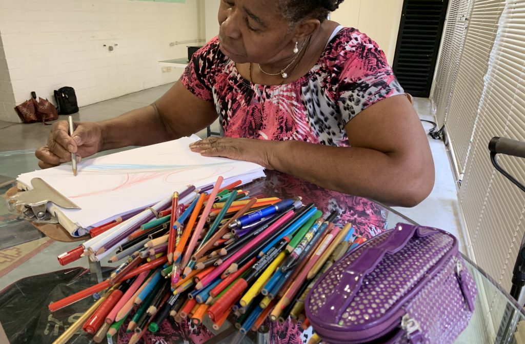 Albita Guerrera doing a healing drawing.